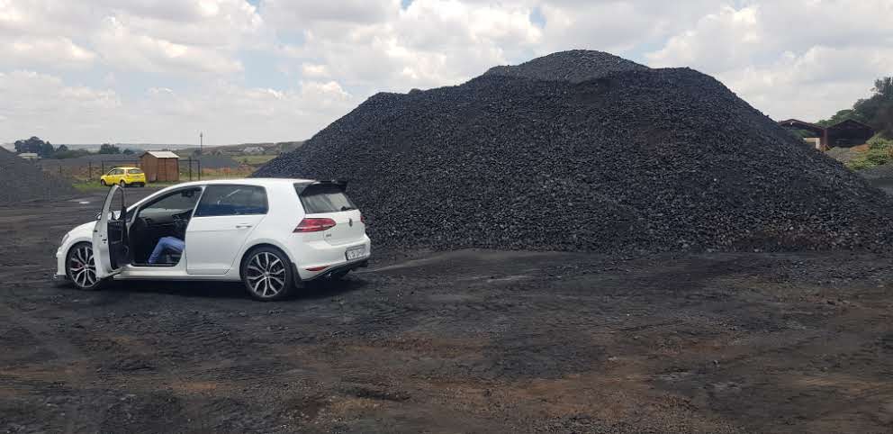 Vehicle on the edge of an active stockpile