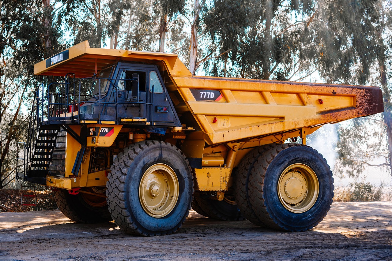 Heavy haul truck under tree cover